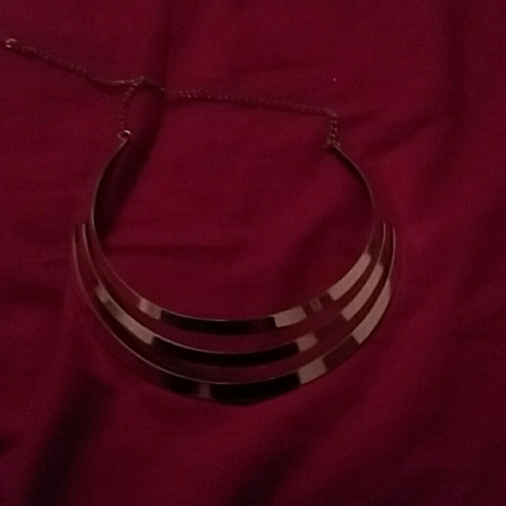 A large, gold-tone necklace